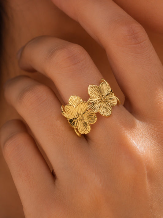 Gold floral ring on a hand