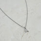A silver chain necklace with a small letter pendants, that can be personalise. A to Z letters gold and silver