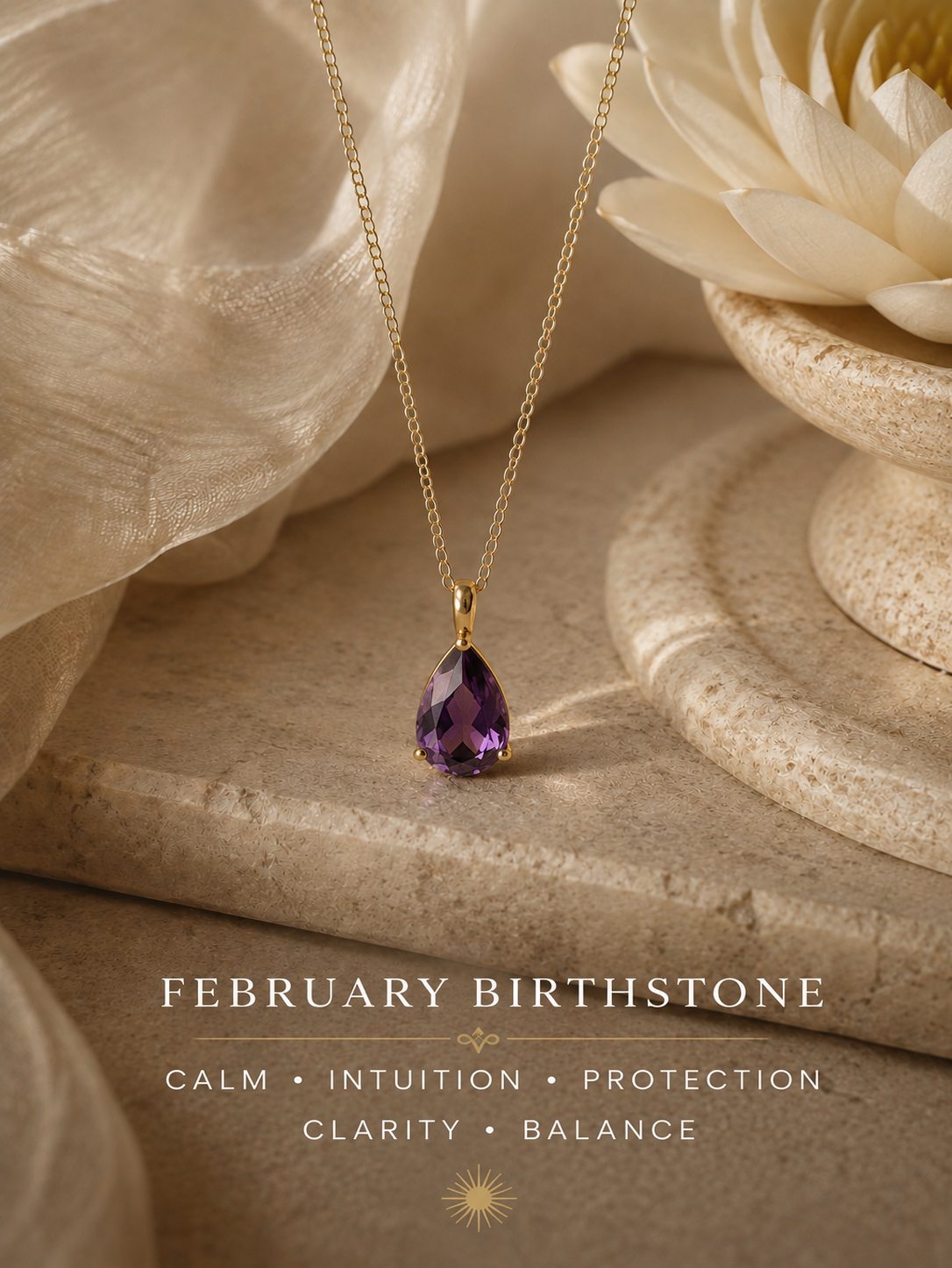 A gold pendant necklace with a teardrop-shaped purple gemstone is displayed on a beige stone surface next to a white flower. Text at the bottom reads 'FEBRUARY BIRTHSTONE' with additional descriptive words.